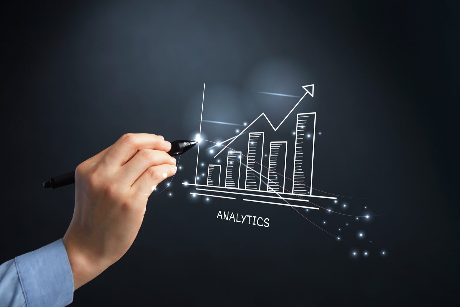 A hand sketching a rising analytics chart