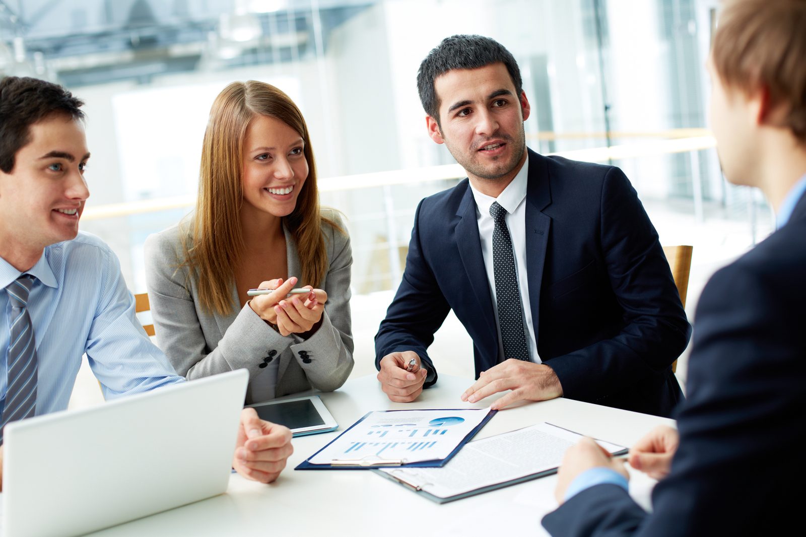Colleagues discussing a workforce report around a meeting table